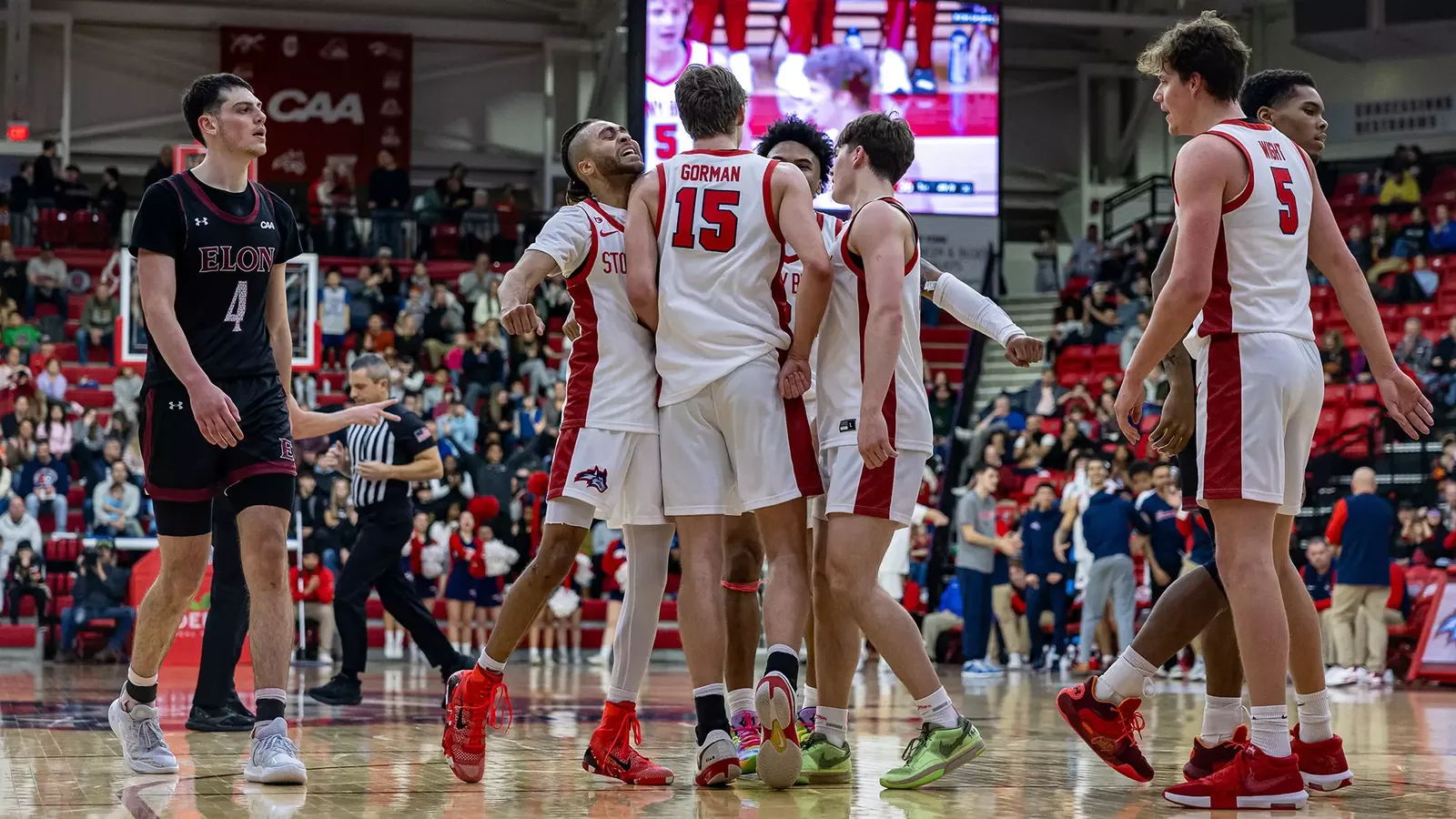 CJ Luster with teammates during a college basketball game